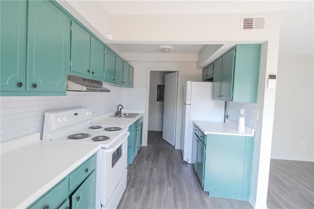 kitchen featuring white appliances, green cabinets, sink, decorative backsplash, and light wood-type flooring