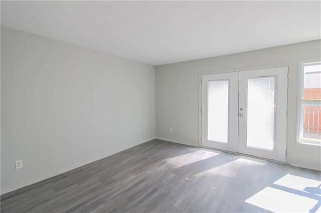 unfurnished room with french doors and dark wood-type flooring