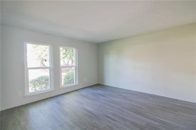 unfurnished room with dark hardwood / wood-style floors