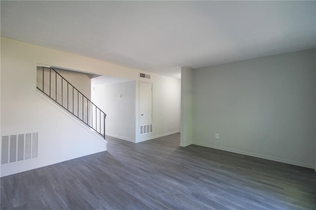 empty room with dark hardwood / wood-style floors