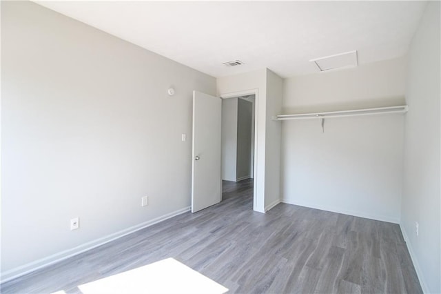 unfurnished bedroom with wood-type flooring and a closet