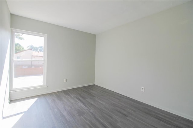 unfurnished room featuring dark hardwood / wood-style flooring