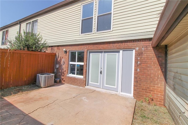 rear view of house featuring central AC and a patio area