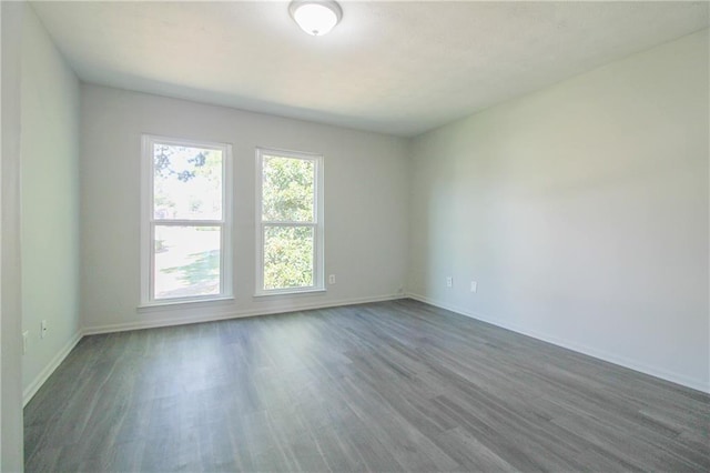 empty room with dark hardwood / wood-style floors