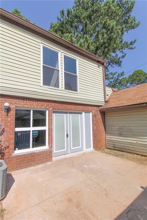 rear view of house featuring a patio area and central air condition unit