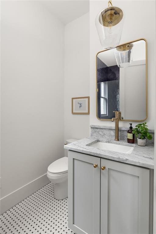 bathroom featuring vanity and toilet