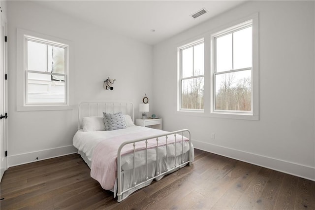 bedroom with dark wood-type flooring