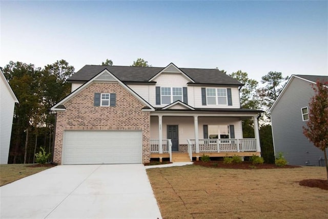 view of front facade with a front lawn, a porch, and a garage