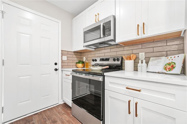 1675 White Oak Way, Decatur, GA 30032 - kitchen with stainless steel appliances, light countertops, backsplash, wood finished floors, and white cabinets