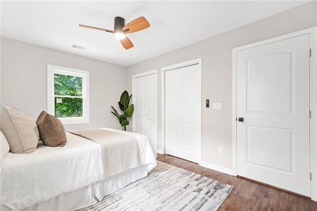 1675 White Oak Way, Decatur, GA 30032 - bedroom with multiple closets, dark wood-style flooring, and a ceiling fan