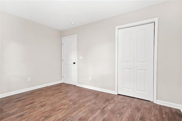 1675 White Oak Way, Decatur, GA 30032 - unfurnished bedroom featuring wood finished floors and a closet