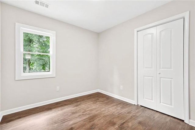 1675 White Oak Way, Decatur, GA 30032 - unfurnished bedroom featuring dark wood finished floors and a closet
