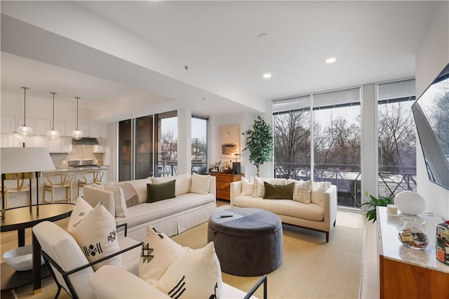 living room featuring a wealth of natural light and a wall of windows