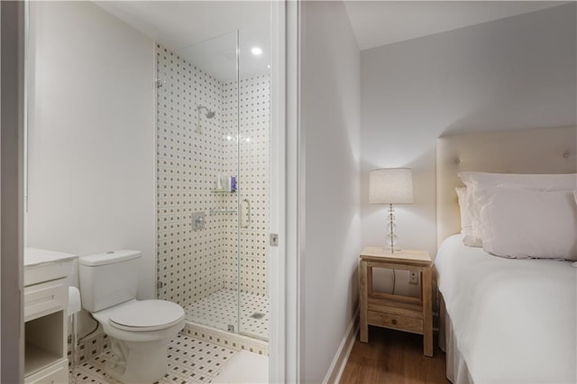 bathroom with walk in shower, vanity, toilet, and hardwood / wood-style flooring