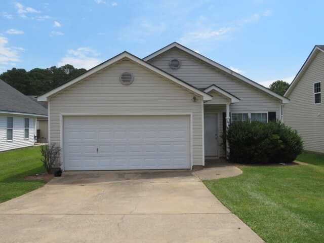 view of front of house with a front lawn and a garage