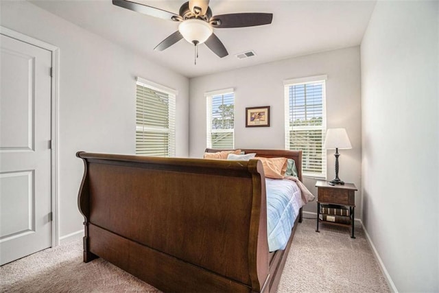bedroom featuring light carpet, baseboards, a ceiling fan, and visible vents
