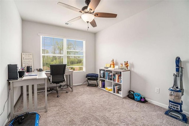 carpeted office space featuring visible vents, baseboards, and a ceiling fan