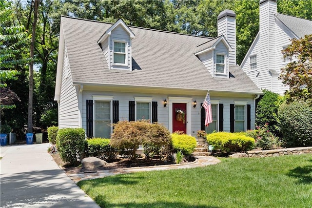 cape cod-style house with a front lawn