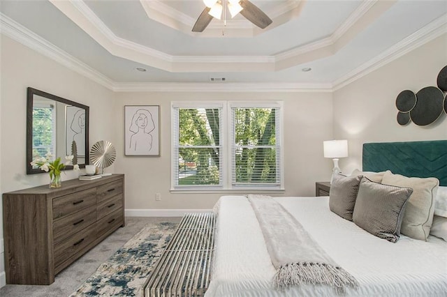 bedroom featuring a raised ceiling, multiple windows, crown molding, baseboards, and ceiling fan