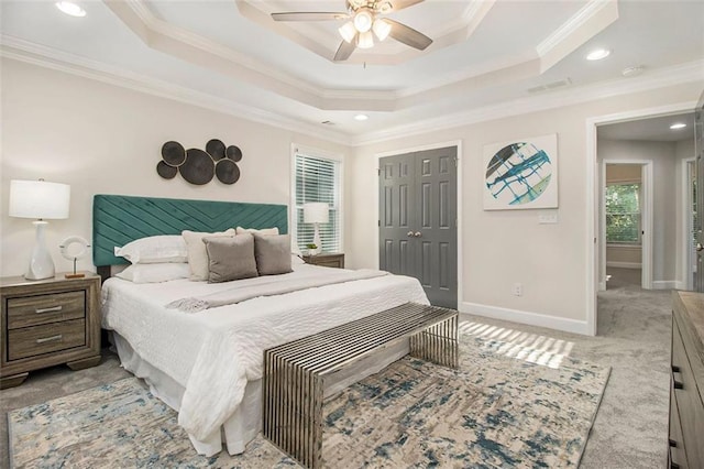 bedroom featuring crown molding, recessed lighting, a raised ceiling, baseboards, and a closet