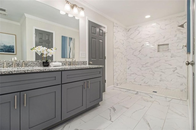 full bath featuring marble finish floors, a tile shower, crown molding, double vanity, and recessed lighting