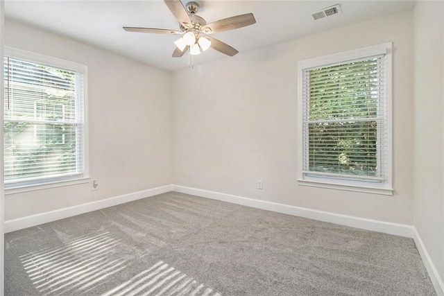 unfurnished room with carpet, baseboards, and ceiling fan