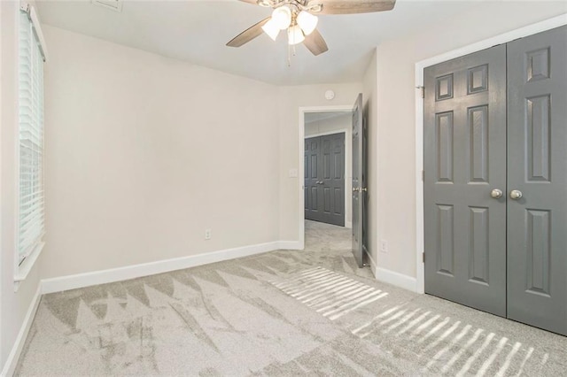 unfurnished bedroom with carpet floors, a closet, and baseboards
