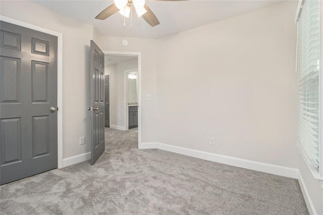 unfurnished bedroom with light carpet, baseboards, and ceiling fan
