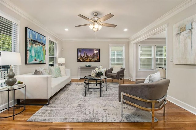 living room featuring a ceiling fan, wood finished floors, baseboards, crown molding, and recessed lighting