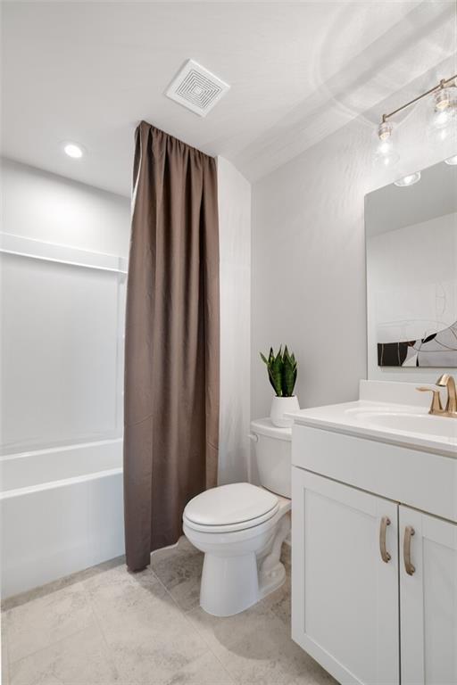 full bathroom featuring vanity, toilet, and shower / bath combo with shower curtain