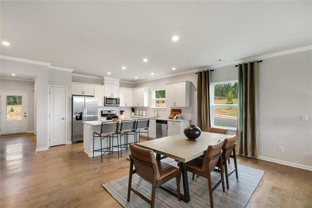 living room with light hardwood / wood-style floors and ornamental molding