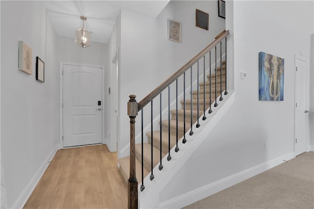 foyer featuring an inviting chandelier and light hardwood / wood-style flooring