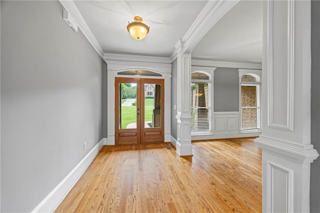 entrance foyer featuring french doors, wood finished floors, and ornamental molding
