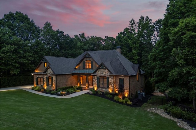 view of front of property with stone siding, a chimney, and covered porch