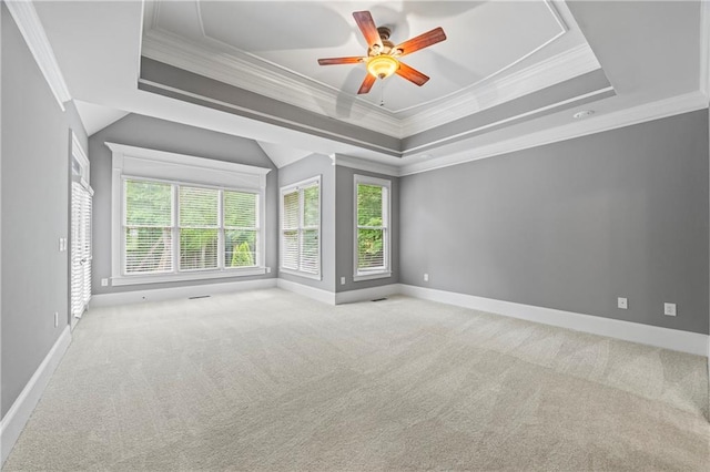 unfurnished room with ornamental molding, a raised ceiling, carpet, baseboards, and ceiling fan