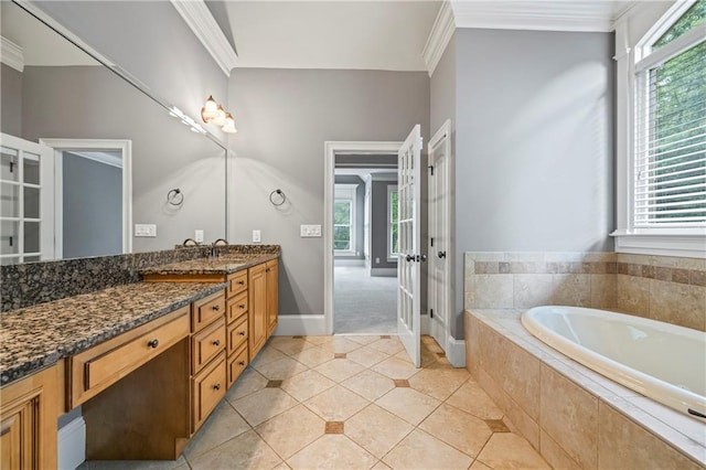 full bathroom featuring vanity, healthy amount of natural light, a garden tub, and ornamental molding