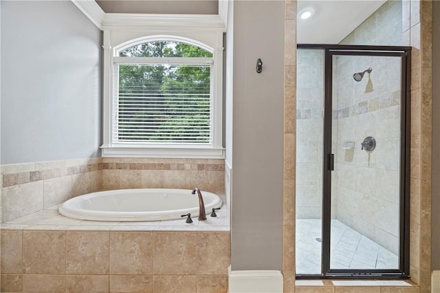 full bath featuring a bath, plenty of natural light, and a shower stall