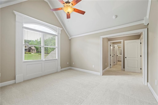 unfurnished room with lofted ceiling, light colored carpet, ceiling fan, crown molding, and a smoke detector