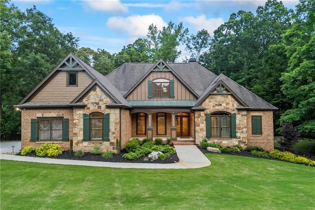 view of front of property with board and batten siding, a front yard, stone siding, and a porch