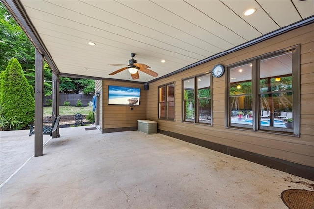 view of patio featuring a ceiling fan and fence