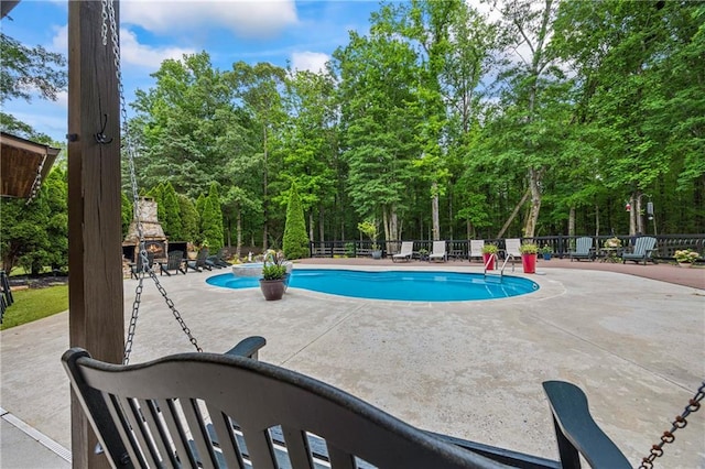 view of swimming pool featuring fence and a patio area