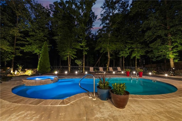 view of swimming pool with a fenced backyard, a patio area, and a pool with connected hot tub