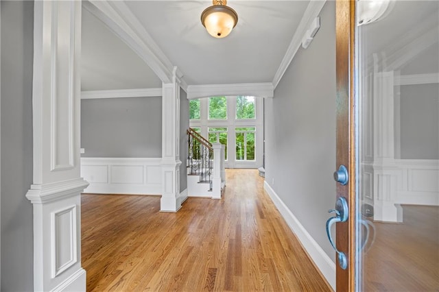 foyer entrance featuring french doors, light wood-type flooring, stairway, and ornamental molding