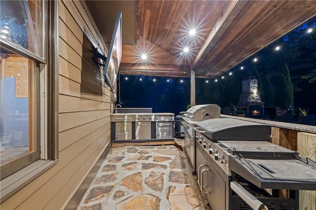 patio at twilight with area for grilling and a sink