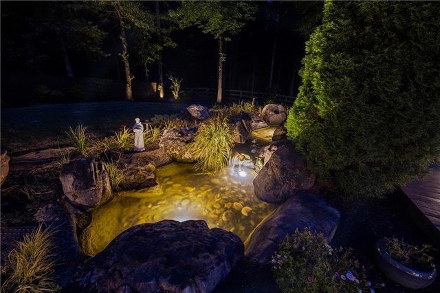 exterior space featuring a garden pond