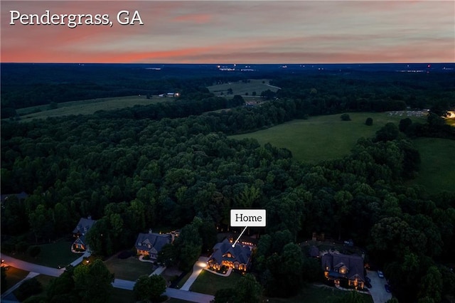 view of property location with a heavily wooded area