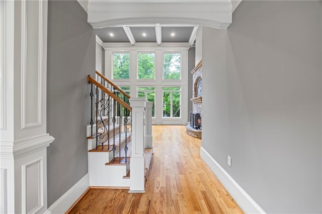 entrance foyer featuring wood finished floors, a high ceiling, crown molding, stairs, and recessed lighting