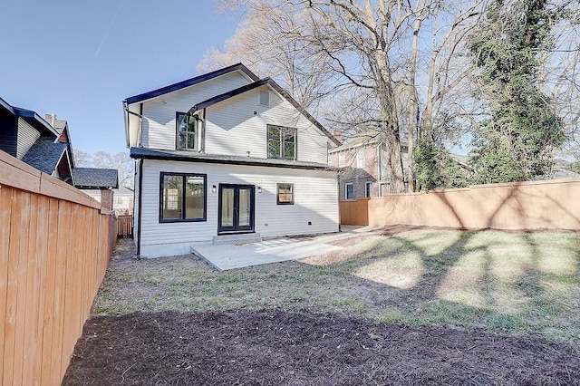 rear view of property with a fenced backyard, a patio, and a lawn