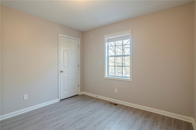 unfurnished room featuring light wood-type flooring