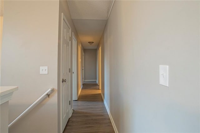 hall featuring dark hardwood / wood-style flooring and a textured ceiling